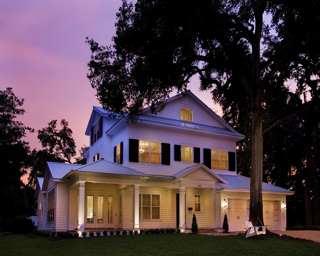 White house with black shutters at dusk