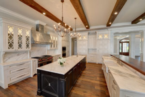 Kitchen with white cabinets, countertops, and large island 