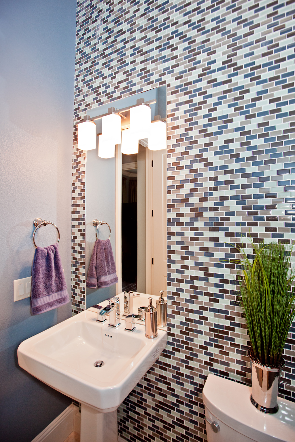 Bathroom Sink With Multi Colored Tiled Wall