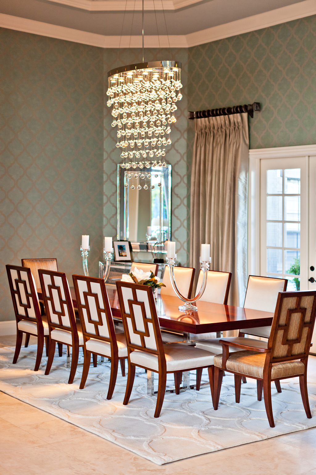 Chandelier above formal dining table and chairs