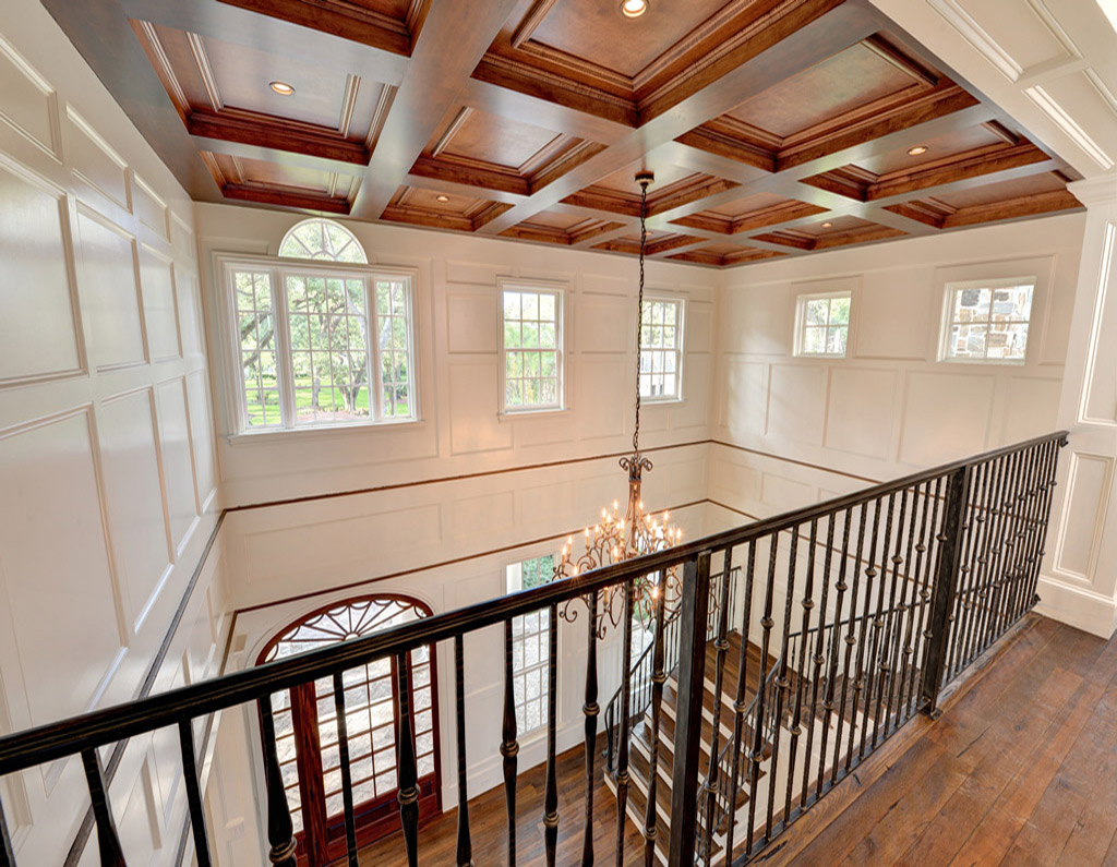 Inside of home with white paneled walls and hardwood floors