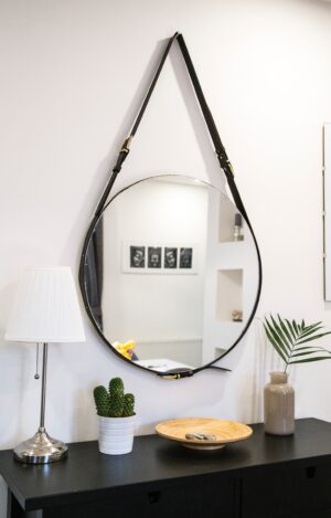 Circular mirror handing in entryway